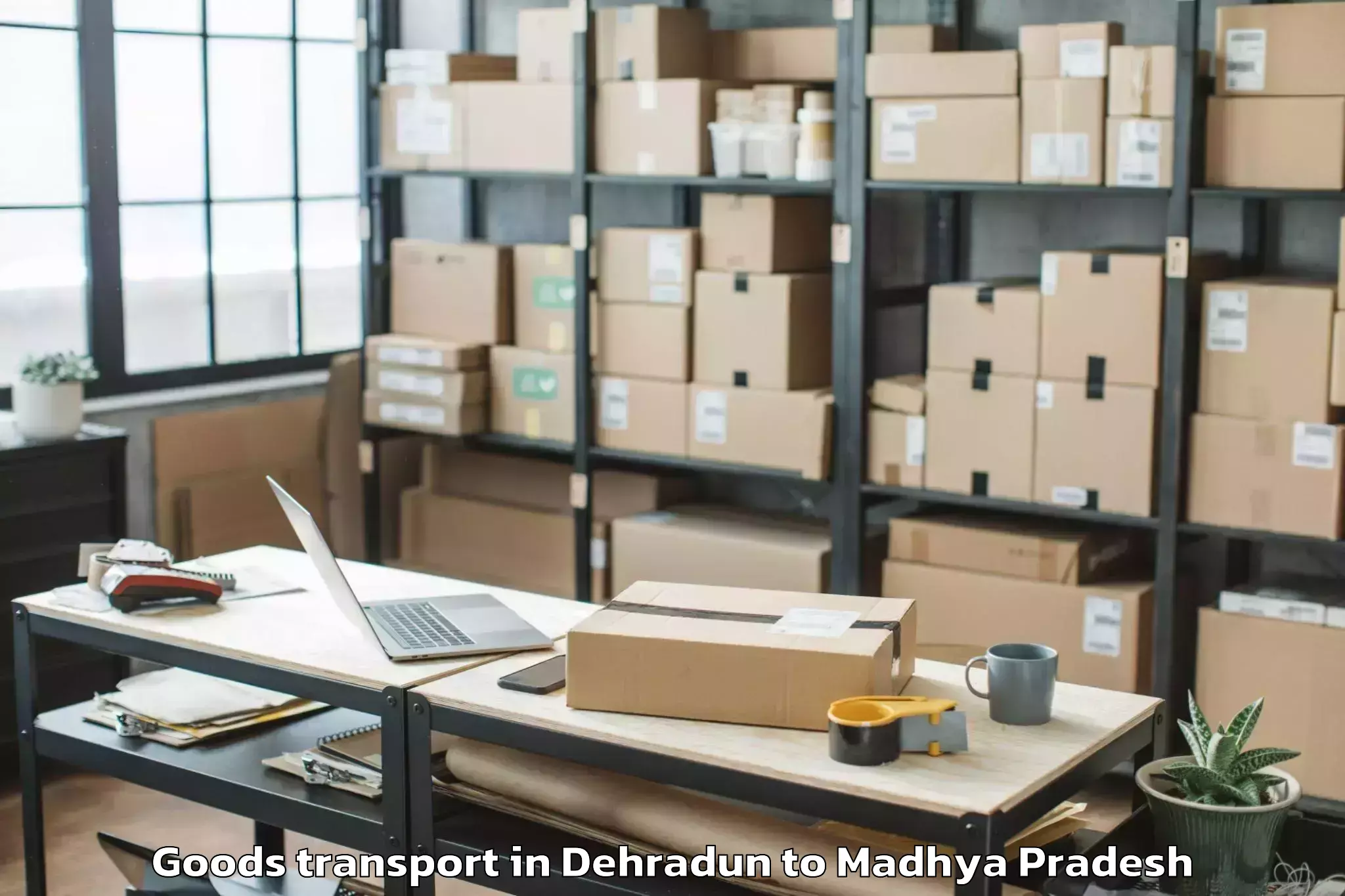 Professional Dehradun to Agar Goods Transport